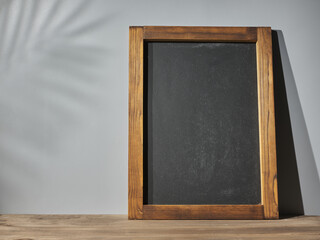 Chalkboard on a background of a gray wall. Mockup for your text