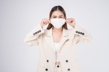 portrait of young businesswoman wearing a surgical mask over white background studio