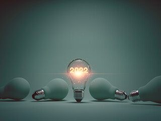 2022 year glowing inside lightbulb among others years for 2022 new business idea concept by 3d...