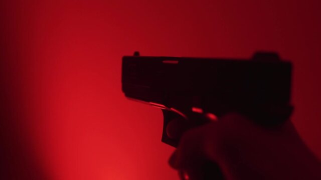 Gun shooting with red background