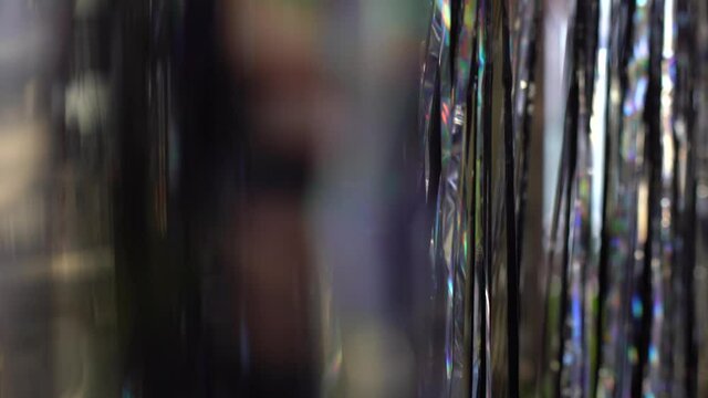 Festive video background. Shiny tinsel in silver and red moves and shines, 4k.