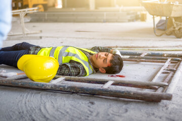 A construction worker falls from a height, his head is hit hard. Accident at construction site....