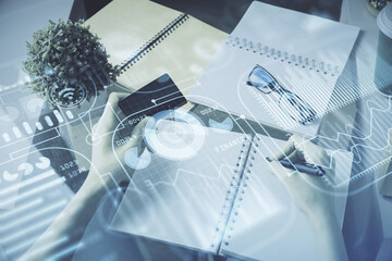 Multi exposure of woman on-line shopping holding a credit card and tech theme drawing. Technology...