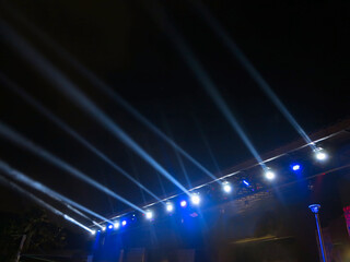 Spotlights on stage with smoke and blue lights