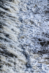 man-made waterfall on a river