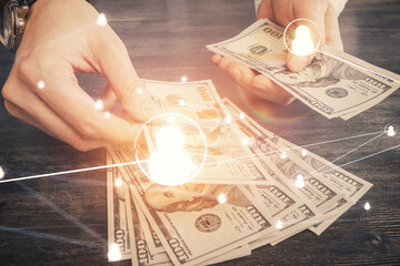 Multi exposure of social network theme drawing hologram and USA dollars bills and man hands.