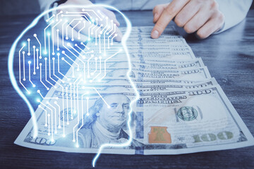 Multi exposure of brain drawing hologram and us dollars bills and man hands. Ai invest concept