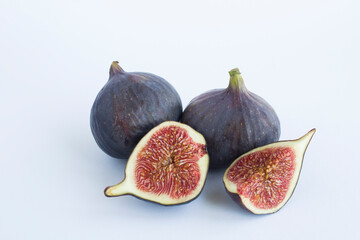 Close-up on ripe blue figs on the white background. Copy space.