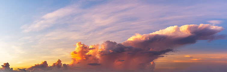 The clouds were exposed to sunlight, creating bright colors in the morning, panoramic sky scene