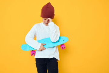 portrait of cute boys in a white sweater skateboard entertainment Childhood lifestyle concept