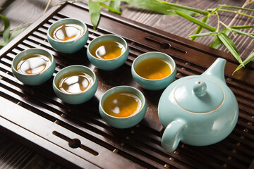 cups of green tea and teapot on  tea tray 