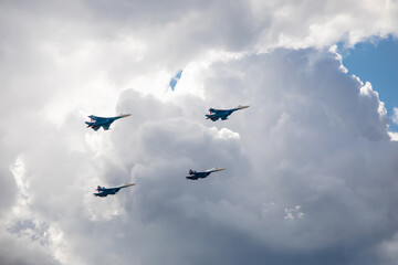 Combat aircraft are flying against the background of the sky. Cloudy sky. Beautiful fighters.