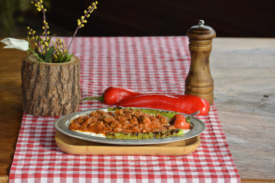 Closeup of alinazik kebab with roasted vegetables on a plate on the table