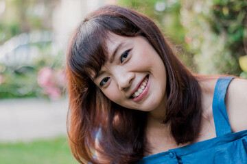 Close up of young pretty Asian woman in the garden.