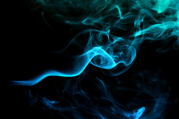 Abstract colored smoke moves on dark background. Wallpaper. Personal vaporizers fragrant steam. Concept of alternative non-nicotine smoking. E-cigarette. Texture. Design elements.