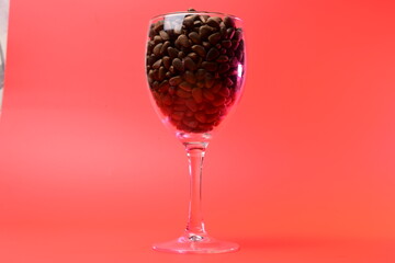 pine nuts in a transparent glass on a red background