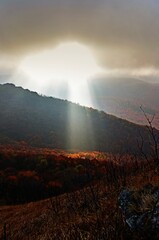 The rays of the sun breaking behind the clouds over Bukowe Berdo, Bieszczady Mountains