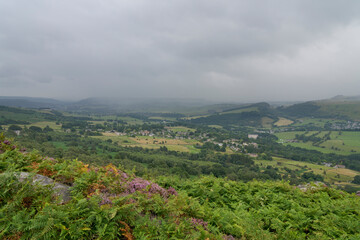 Naklejka premium Heavy cloud and mist drops down over the Derbyshire countryside on an August summer morning.