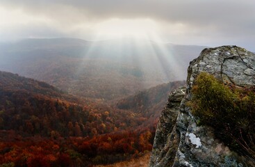 The rays of the sun breaking behind the clouds over Bukowe Berdo, Bieszczady Mountains
