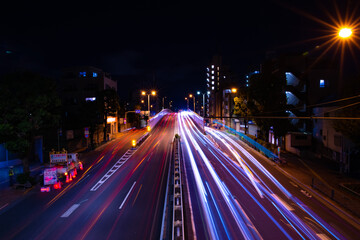 Fototapeta na wymiar A night downtown street in Tokyo wide shot