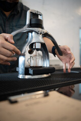 Barista preparing black coffee in a coffee shop.Hands of barista making manual espresso iced coffee.