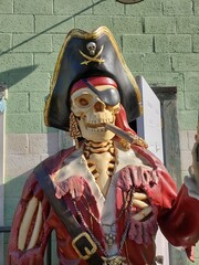 Skeleton pirate smoking a cigar and holding a pistol