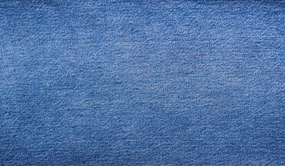 The texture of a beautiful denim of a classic color. Close-up.