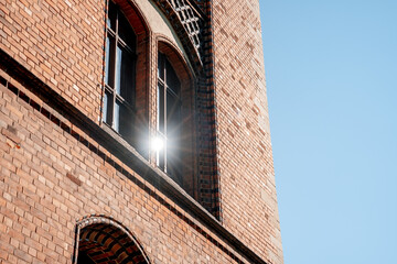 Sunbeam in glass vintage windows of red brick building (1022)