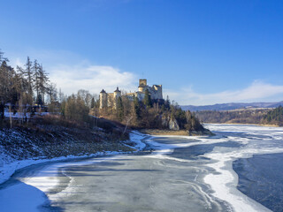 Medieval castle in Niedzica, Poland, in winter at partially frozen artificial Czorsztyn lake on Dunajec river