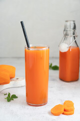 Glass of carrot juice, healthy smoothie drink with paper straw. Nutrition and diet concept