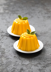 Pumpkin Panna Cotta on a plate on a dark gray background