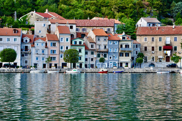 Obraz premium Bakar, Croatia September 2021. Colorful picturesque mediterranean Bakar city and reflex of houses on the sea