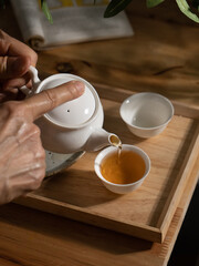 oolong chinese tea drink in a white porcelain teapot and teacup