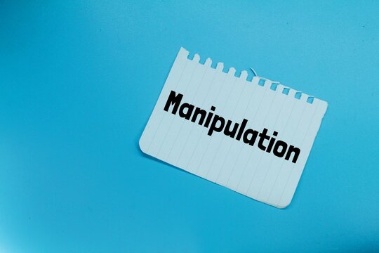 white paper torn with the word manipulation
