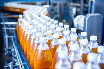 Conveyor belt with bottles for juice or water at a modern beverage plant