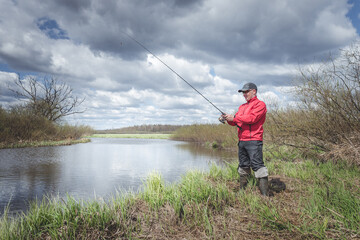 Fisherman on the banks of a picturesque river.