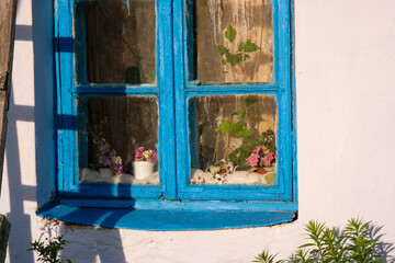 Part of an old village house with a window in Ukraine. Ancient insulation of the window frame with cotton wool. 
