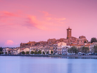 Fototapeta na wymiar pink sky above city Marta on lake Bolsena in Italy