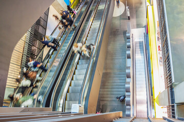 People on escalators in a shopping centre