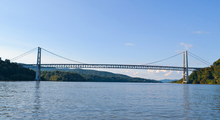 Full span of the Bear Mountain Bridge as seen from the Hudson River - obrazy, fototapety, plakaty
