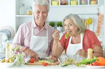 Obraz na płótnie Canvas Close up portrait of senior couple cooking