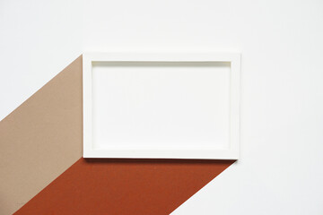 blank clean white horizontal paper frame with two colors of brown paper and beige paper against white paper background, top view, flat lay.