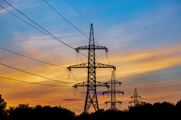 Fototapeta premium High voltage electric industrial gear against the backdrop of a picturesque sunset