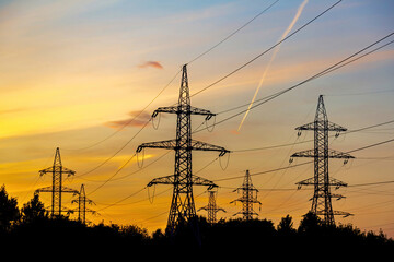 Fototapeta premium High voltage electric industrial gear against the backdrop of a picturesque sunset