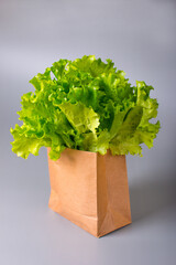 green lettuce leaves in a paper ecological bag. Healthy lifestyle and nutrition
