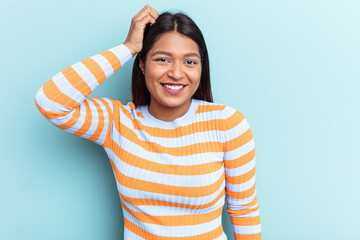 Young Venezuelan woman isolated on blue background being shocked, she has remembered important meeting.