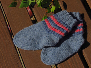 knitted socks on a wooden background