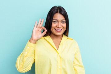 Young Venezuelan woman isolated on blue background cheerful and confident showing ok gesture.