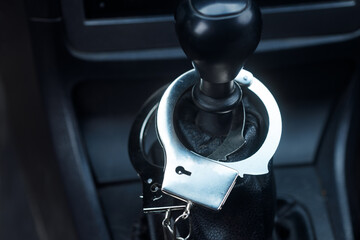 handcuffs hang in the car on the gear knob. road crimes