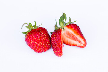 strawberry with sliced half and leaves isolated on white background with clipping path.